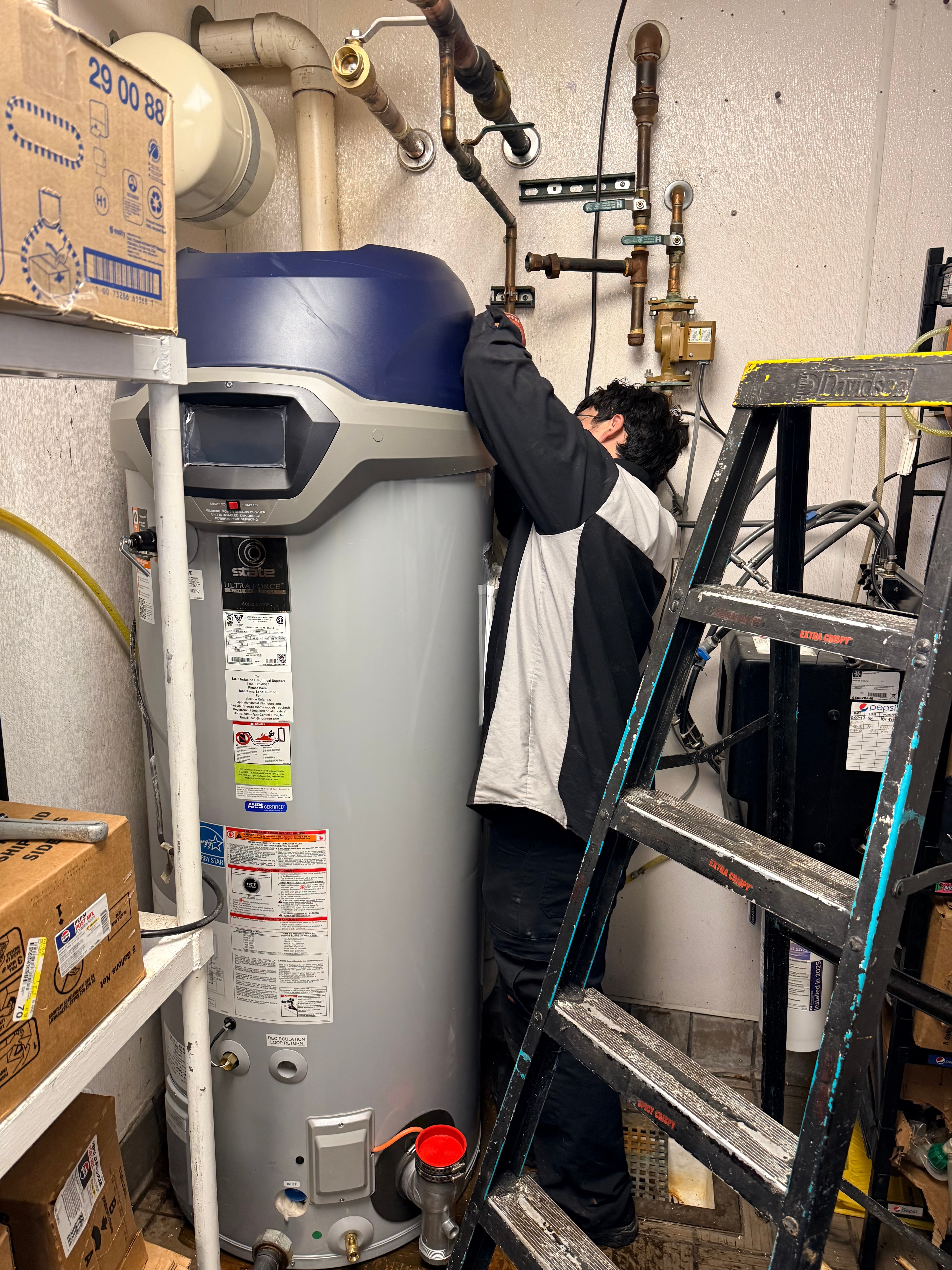 Technician servicing commercial boiler equipment
